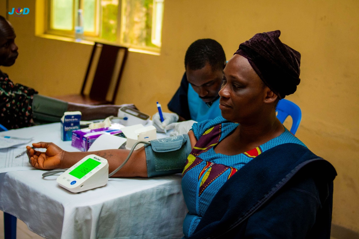 Students sitting in a classroom raising hands